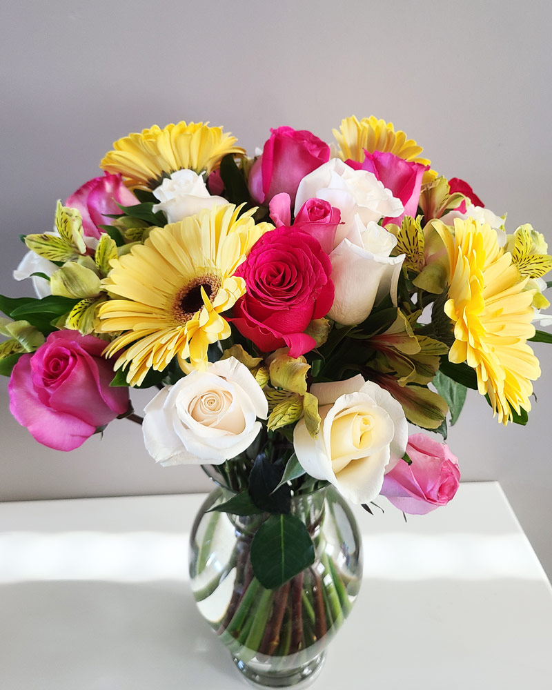 really large flower arrangement with gerbera daisies and roses in a vase